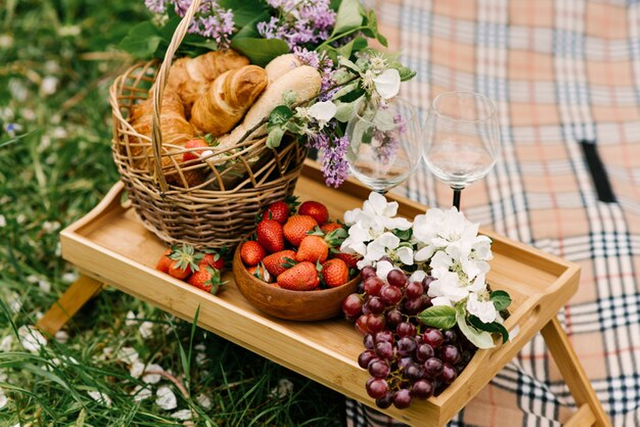 Picnic setup with a tray of fruits and bread