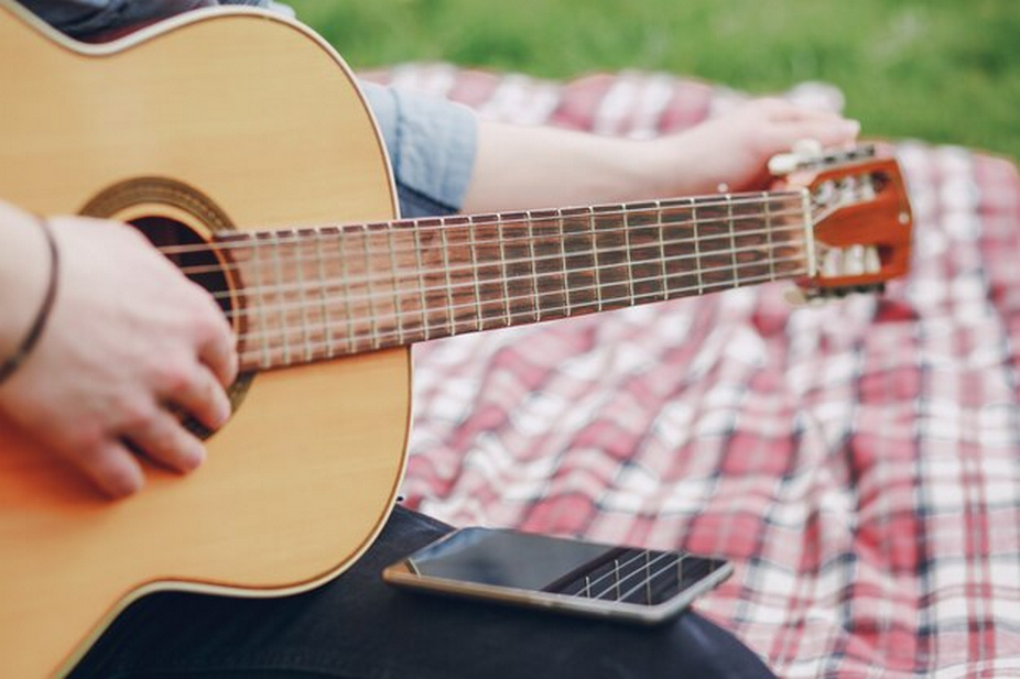 Person playing a guitar